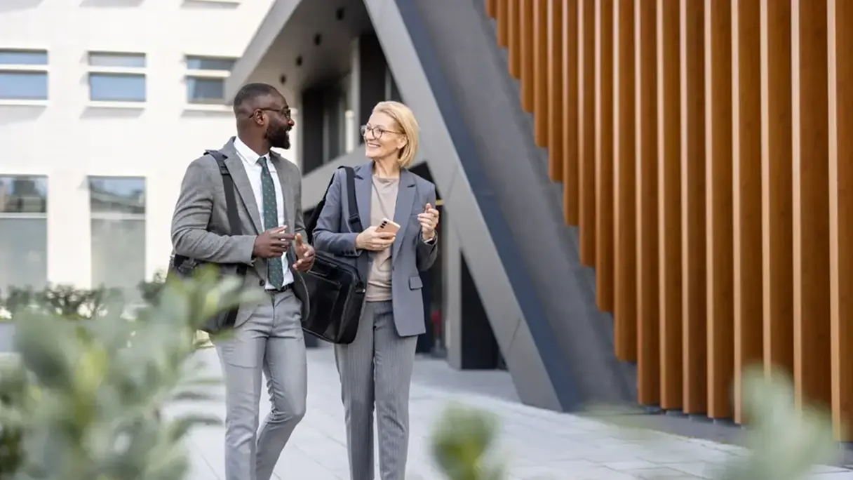 A man and a woman arriving at an office building and discussing access management. 