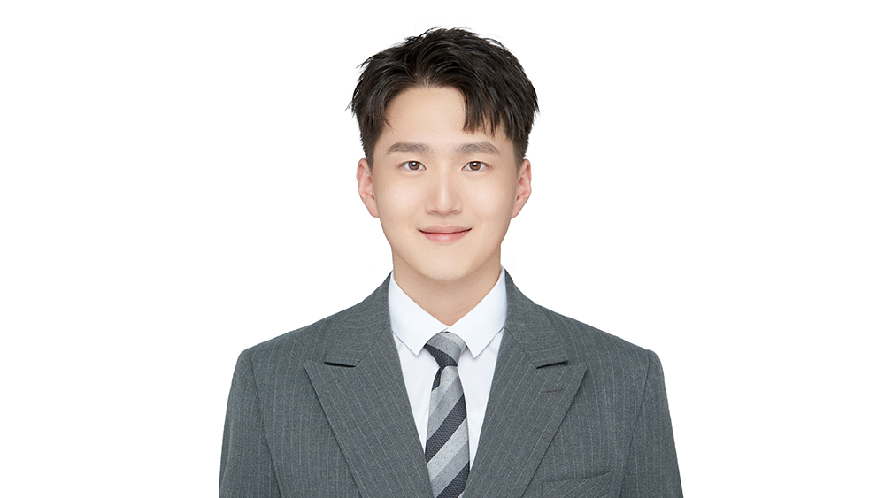 Josh He, product sales specialist at Shorelight - China, and Auburn University alum, smiles for the camera.