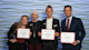Four students from the University of South Carolina pose and hold their winning certificate from the Darla Moore School of Business Annual Sales Competition