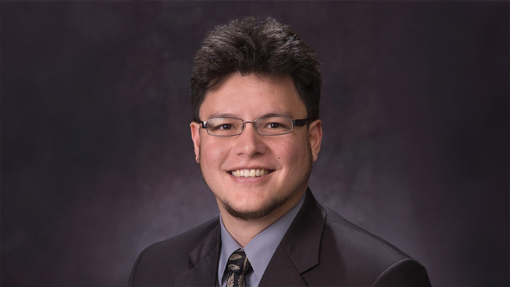 Jawee Perla, student success leader for the International Accelerator Program at American University in Washington, DC, smiles for the camera.