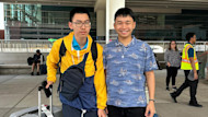 Hung and Hieu, two brothers from Vietnam studying at the University of Utah, stand at the airport with their luggage and smile for the camera