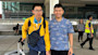Hung and Hieu, two brothers from Vietnam studying at the University of Utah, stand at the airport with their luggage and smile for the camera