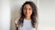 Asiye from Turkey, student advisor at the University of South Carolina International Accelerator Program, stands outside on the USC campus and smiles for the camera.