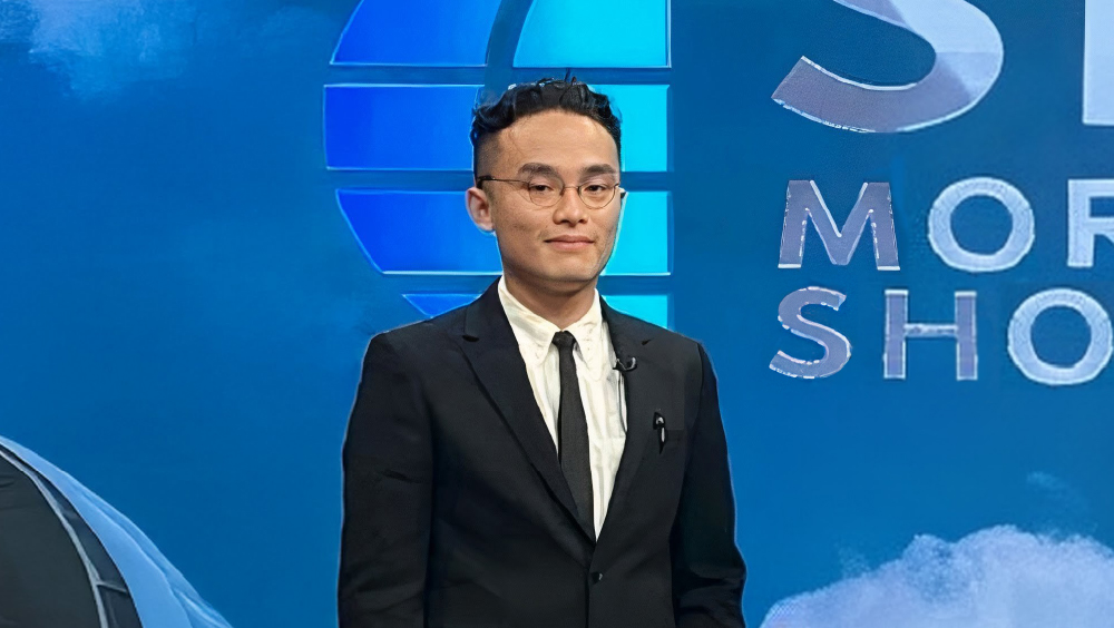 Reynard Misae, founder of Ploopy Animation, stands on set at a morning television show in Indonesia.