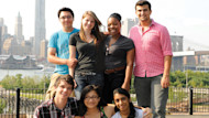 A group of international students posing for a picture with New York City in the background
