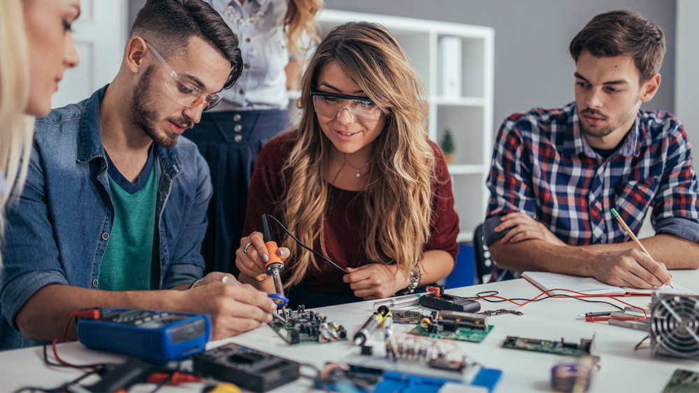 International students working on a circuit board