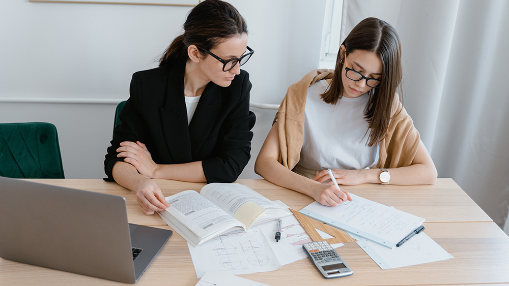 International student meeting and getting personal tutoring from a professor
