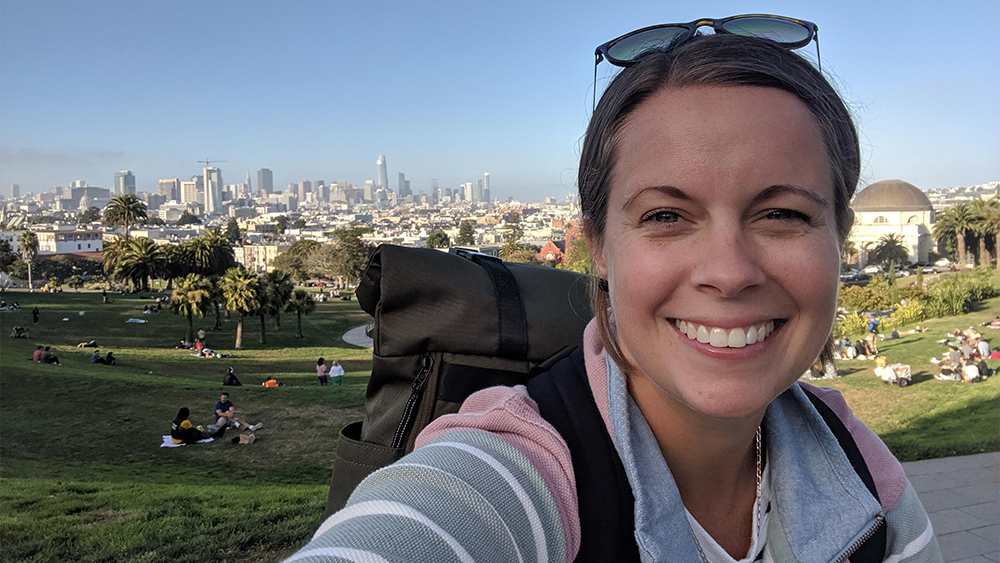 Shorelight Director of Partner Operations Caitlin Phillips Rivera smiles for the camera while on a backpacking trip