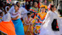 A group of Latina women in traditional dress dance for a festival in Salt Lake City.
