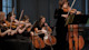 An all-female string section of an orchestra