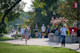 International students walking on the campus garden with UWRF banners in the background.