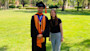 Abdullah from Pakistan, class of 2025 valedictorian at the University of the Pacific, stands on campus in his graduation robes alongside Jelena from UOP International.