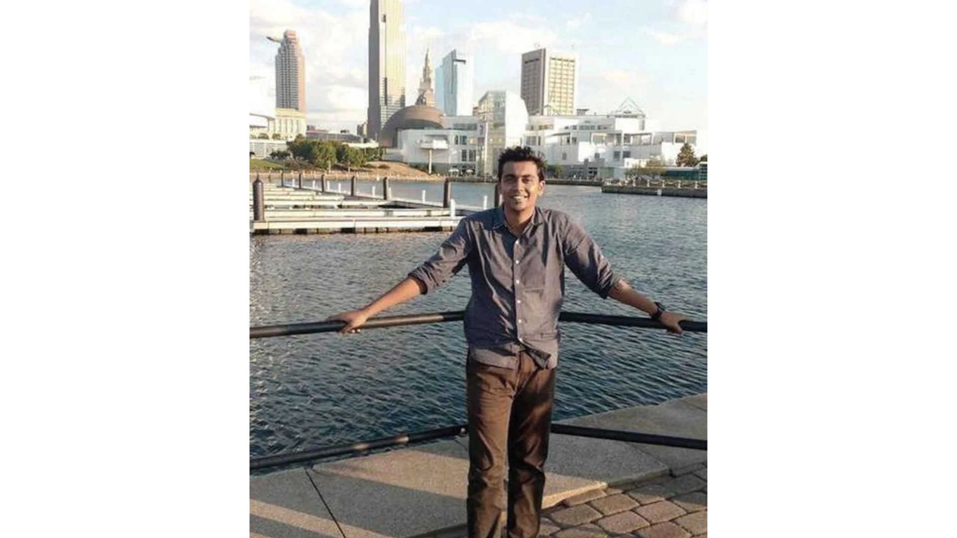 A photo of K. Aditya at Cleveland State University standing in front of the Cleveland skyline