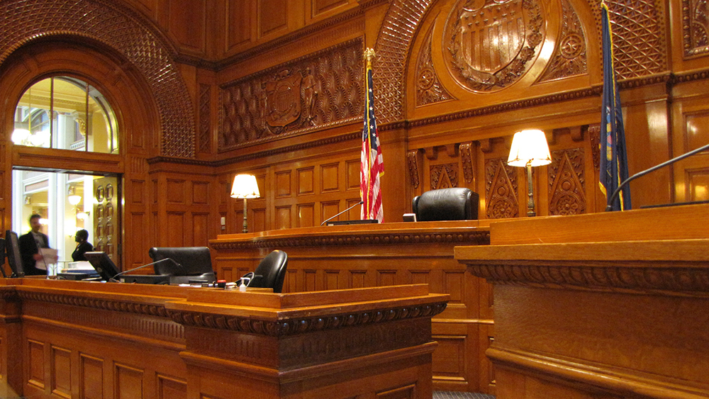 This photo shows an empty criminal court with lawyers at the open doors. Pursue a career in criminal justice or criminology by taking criminology courses at a US university with Shorelight. 