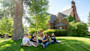 A group of students sit outside on a grassy hill on campus at the University of Wyoming in Laramie, Wyoming