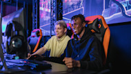 Two international students playing together at a gaming tournament