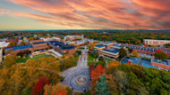 This photo shows an aerial view of Stony Brook University in New York state under a colorful sunset.