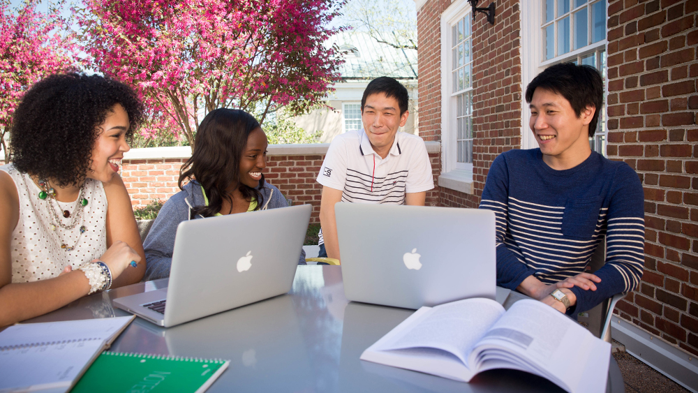 A group of international students studying in an outdoor space at the University of South Carolina.