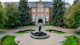 A fountain, circular gardens, evergreen trees, and brick building on the Gonzaga University campus in Spokane, Washington