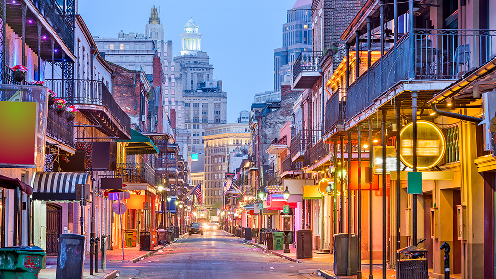 This photo shows New Orleans' French Quarter lit up at night. International students can study abroad in NOLA by applying to Tulane University through Shorelight.