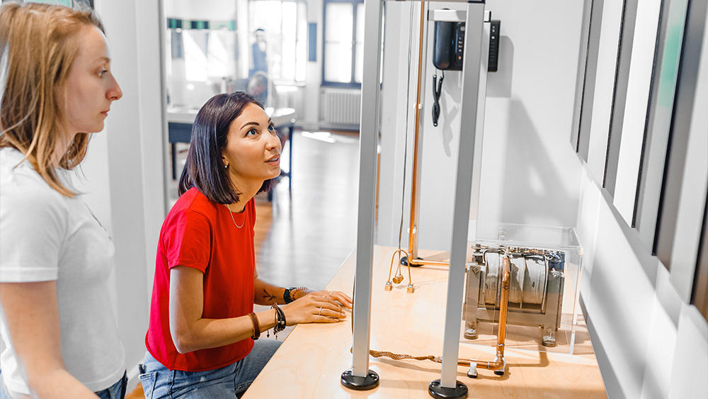 Two female international students work in a lab for their physics course at a US university.
