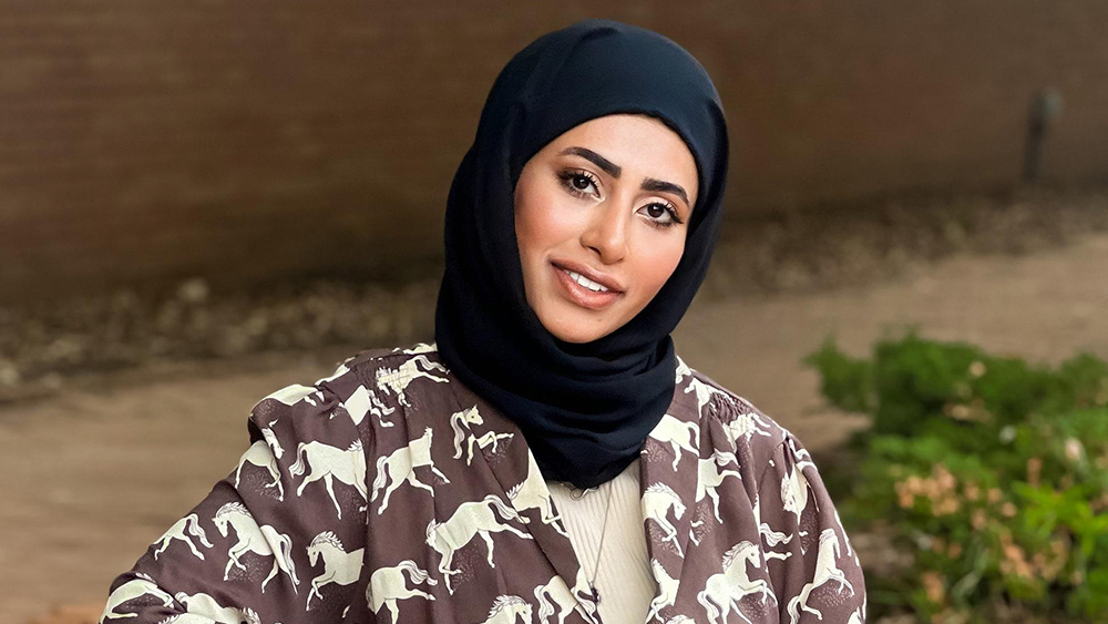 Fatimah, a Saudi Arabian student at the University of South Carolina, smiles for the camera while prepping for a modeling assignment.