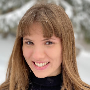 Emma Boehm, product marketing coordinator at Shorelight, stands in a snowy field and smiles for the camera