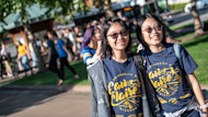 This photo shows two female Asian students standing outside on campus at the University of Wisconsin-Eau Claire