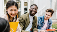 Three international students with the Applied AI in Engineering Summer Institute at the University of California, Berkeley, in collaboration with Shorelight, sit together on campus and laugh during a break. 