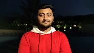 Avadh, an international student from India and student ambassador for UIC Global, wears a red sweatshirt with a white hood and smiles for the camera