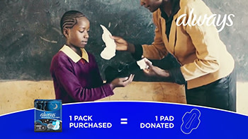 A teacher provides a female student with a sanitary pad. Along the bottom of the image, a blue graphic with white text says, "1 pack purchased equals 1 pad donated."