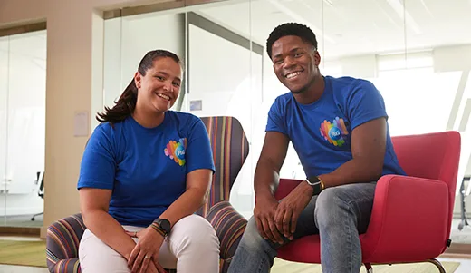 Two P&G employees sitting in chairs