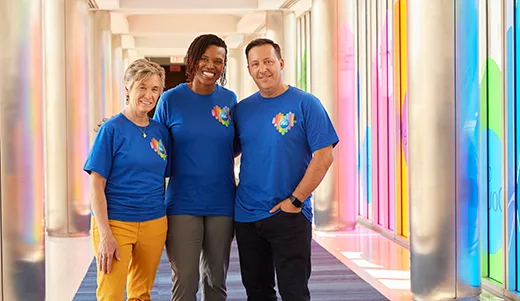 Three P&G employees standing in a hallway