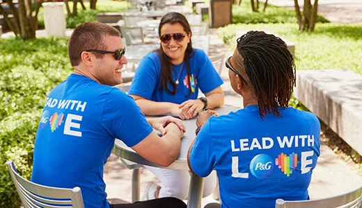 Three people talking around a table