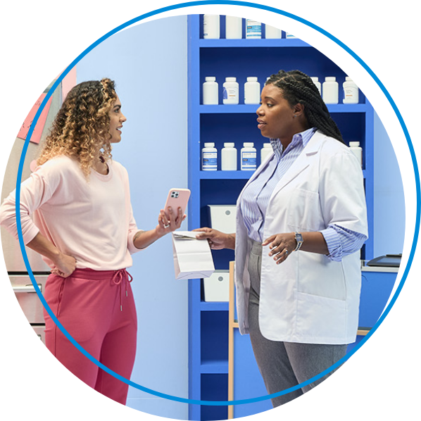 Pharmacist speaking with patient about prescription