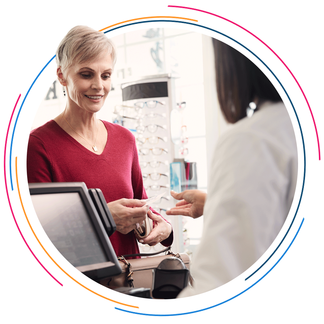 A patient pays for a prescription at the pharmacy counter