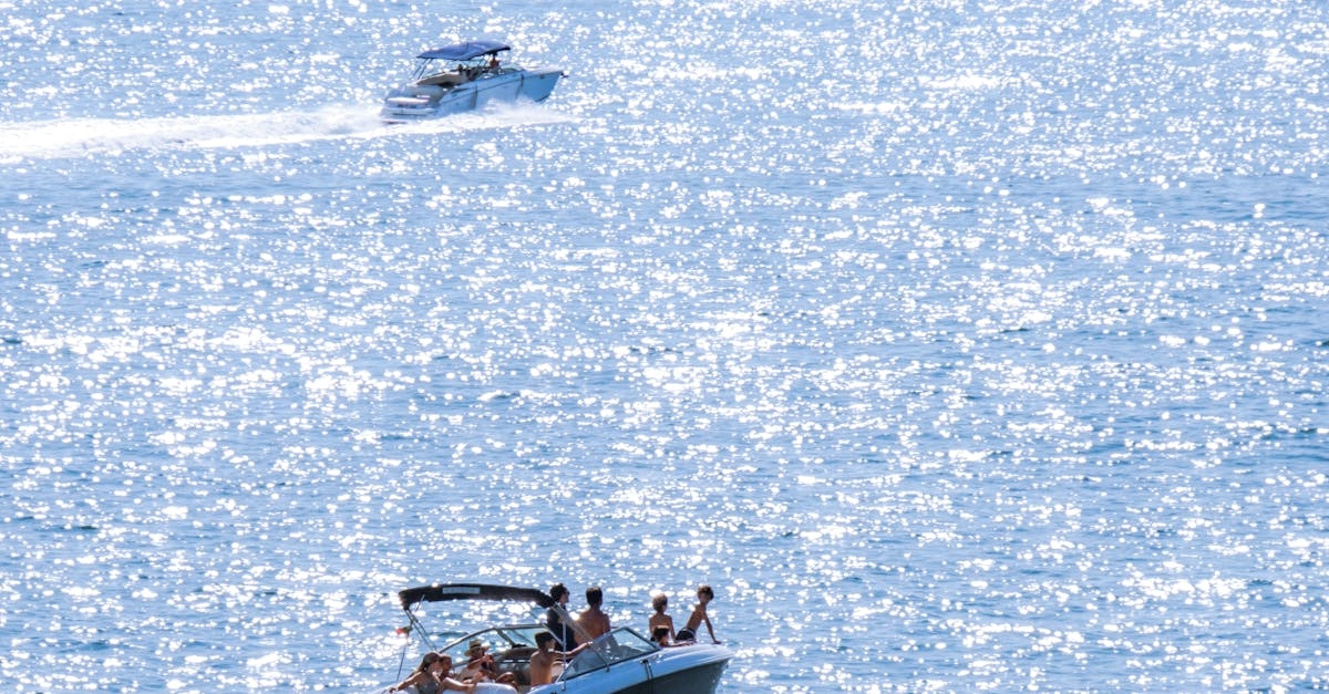 Drone Shot of People Riding on White Boat Sailing on the Sea