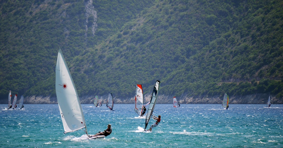 Man in Black Top Ridding Sailboat