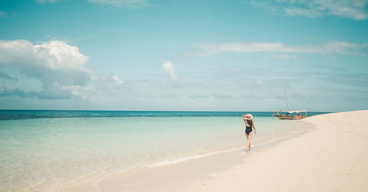 Woman in Black Swimsuit Walking on the Beach