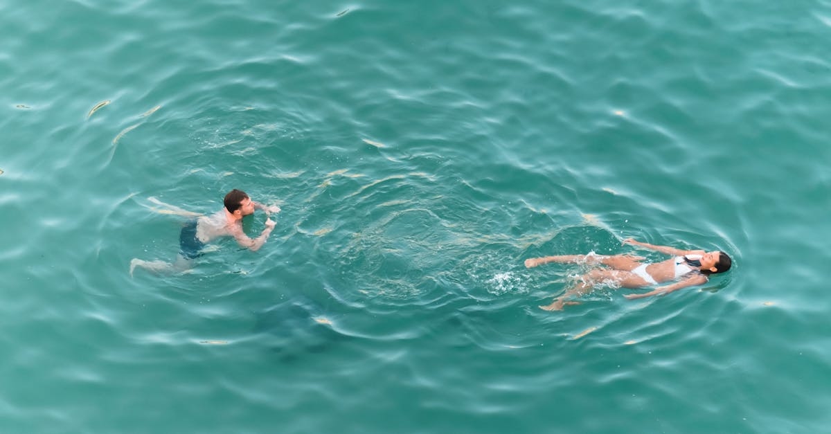 A Couple Swimming on a Turquoise Water