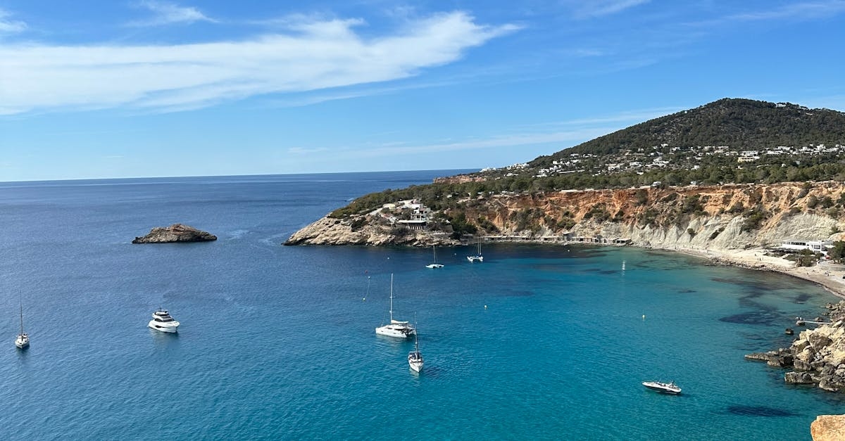 Motor Yachts and Motorboats on Sea near Rock