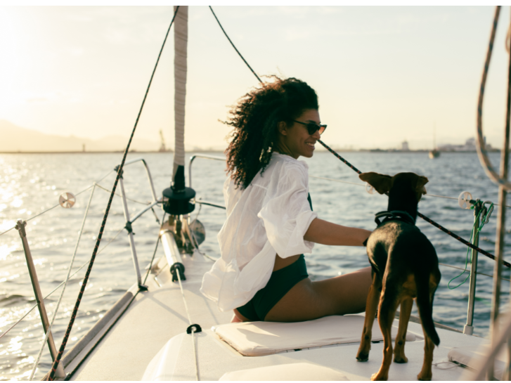 Woman and a dog on the boat