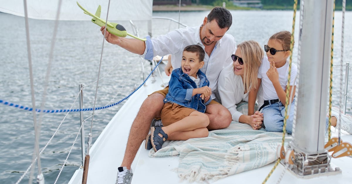 Full body of family in summer clothes having fun together on yacht in summer day