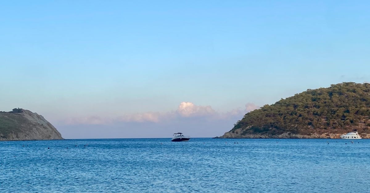 A boat is sailing in the ocean near a small island
