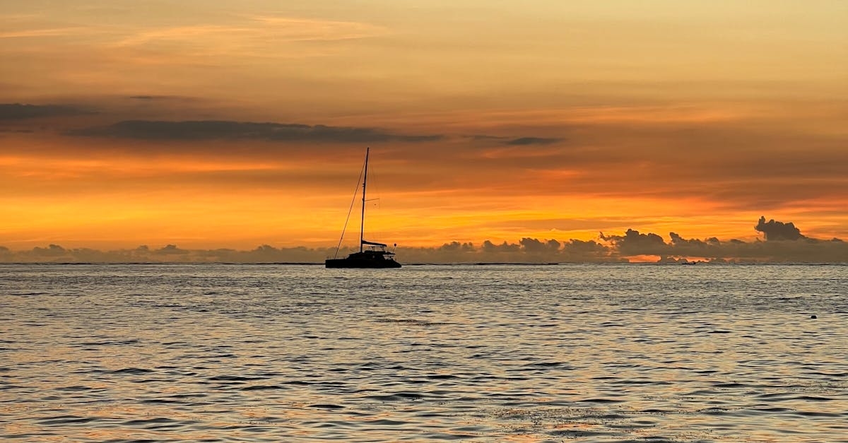 Sailboat on Ocean at Sunset