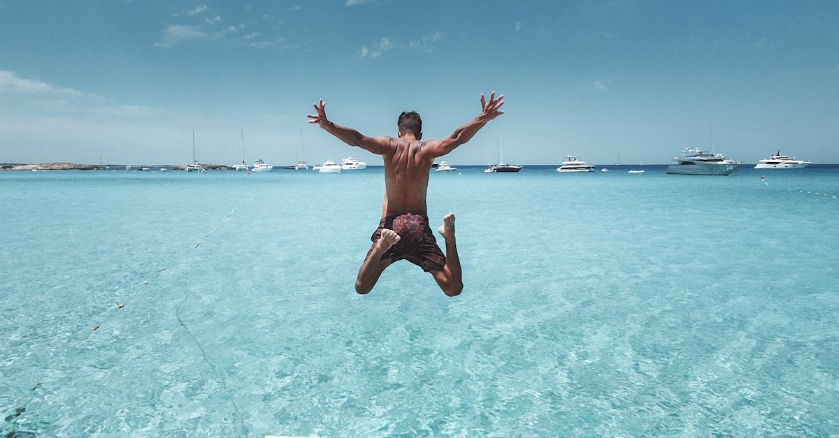 Man Jumping From the Dock into the Sea