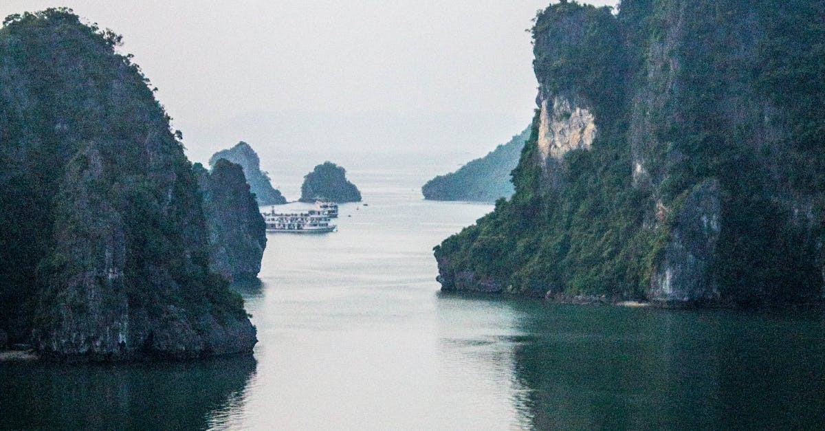 Rock Formations Surrounded by Body of Water