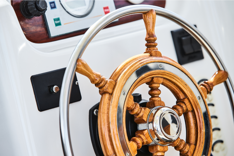 A classic looking steering wheel of a boat with a modern design