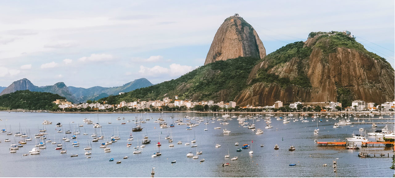 water with boats in brazil with mountains in distance