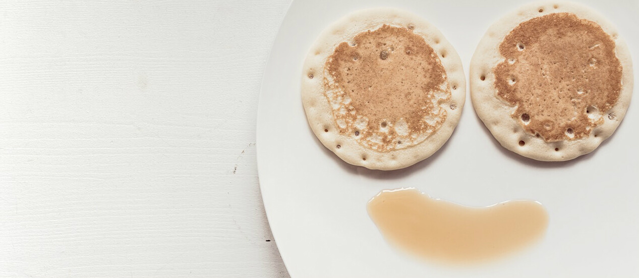 breakfast-pancakes-and-syrup-in-smiley-face-on-plate